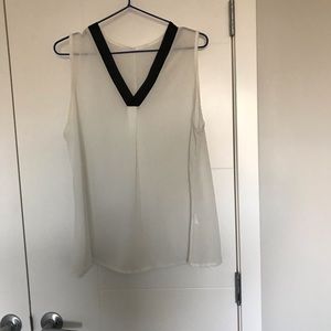 White sleeveless see through blouse.
